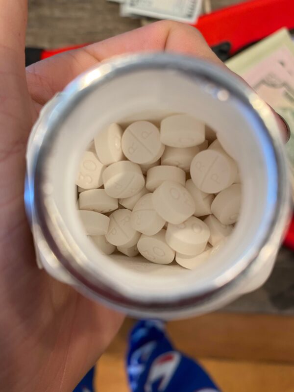 Oxycodone Hydrochloride Oxycodone, sold under various brand names such as Roxicodone and OxyContin (which is the extended release form), is a semi-synthetic opioid used medically for treatment of moderate to severe pain. It is highly addictive and It is usually taken by mouth, and is available in immediate-release and controlled-release formulations. Onset of pain relief typically begins within fifteen minutes and lasts for up to six hours with the immediate-release formulation. In the United Kingdom, it is available by injection. Combination products are also available with paracetamol (acetaminophen), ibuprofen, naloxone, naltrexone, and aspirin. Medical uses Oxycodone is used for managing moderate to severe acute or chronic pain when other treatments are not sufficient. It may improve quality of life in certain types of pain. Numerous studies have been completed, and the appropriate use of this compound does improve the quality of life of patients with long term chronic pain syndromes. Oxycodone is available as a controlled-release tablet, intended to be taken every 12 hours. A 2006 review found that controlled-release oxycodone is comparable to immediate-release oxycodone, morphine, and hydromorphone in management of moderate to severe cancer pain, with fewer side effects than morphine. The author concluded that the controlled-release form is a valid alternative to morphine and a first-line treatment for cancer pain. In 2014, the European Association for Palliative Care recommended oxycodone by mouth as a second-line alternative to morphine by mouth for cancer pain. Available forms See also: Oxycodone/paracetamol, Oxycodone/aspirin, Oxycodone/ibuprofen, and Oxycodone/naloxone Both sides of a single 10mg OxyContin pill. Oxycodone is available in a variety of formulations for by mouth or under the tongue: Immediate-release oxycodone (OxyFast, OxyIR, OxyNorm, Roxicodone) Controlled-release oxycodone (OxyContin, Xtampza ER) – 10–12 hour duration Oxycodone tamper-resistant (OxyContin OTR) Immediate-release oxycodone with paracetamol (acetaminophen) (Percocet, Endocet, Roxicet, Tylox) Immediate-release oxycodone with aspirin (Endodan, Oxycodan, Percodan, Roxiprin) Immediate-release oxycodone with ibuprofen (Combunox) Controlled-release oxycodone with naloxone (Targin, Targiniq, Targinact)[38] – 10–12 hour duration Controlled-release oxycodone with naltrexone (Troxyca) – 10–12 hour duration A liquid solution containing 10mg of oxycodone per 1ml In the US, oxycodone is only approved for use by mouth, available as tablets and oral solutions. Parenteral formulations of oxycodone (brand name OxyNorm) are also available in other parts of the world, however, and are widely used in the European Union. In Spain, the Netherlands and the United Kingdom, oxycodone is approved for intravenous (IV) and intramuscular (IM) use. When first introduced in Germany during World War I, both IV and IM administrations of oxycodone were commonly used for postoperative pain management of Central Powers soldiers. Oxycodone, like other opioid analgesics, tends to induce feelings of euphoria, relaxation and reduced anxiety in those who are occasional users. These effects make it one of the most commonly abused pharmaceutical drugs in the United States. The abuse of Oxycodone, as well as related opioids more broadly, is not unique to the United States and is a common drug of abuse globally. Uses for Oxycodone Acute Pain Relief of moderate to severe pain when use of an opiate analgesic is appropriate and alternative treatments are inadequate. Usually, temporary relief of moderate to moderately severe pain such as that associated with acute and some chronic medical disorders including renal or biliary colic, acute trauma, postoperative pain, and cancer. Opiates given orally in combination with acetaminophen or NSAIAs may produce greater analgesic effect than either drug alone; may also cause fewer adverse effects than equianalgesic doses of the individual drugs alone. Extended-release oxycodone hydrochloride/acetaminophen in fixed combination: Relief of acute pain that is severe enough to require opiate therapy and for which alternative treatments (e.g., nonopiate analgesics) are inadequate or not tolerated. In symptomatic treatment of acute pain, reserve opiate analgesics for pain resulting from severe injuries, severe medical conditions, or surgical procedures, or when nonopiate alternatives for relieving pain and restoring function are expected to be ineffective or are contraindicated. Use smallest effective dosage for shortest possible duration since long-term opiate use often begins with treatment of acute pain. Optimize concomitant use of other appropriate therapies. (See Managing Opiate Therapy for Acute Pain under Dosage and Administration.) Reserve oxycodone hydrochloride extended-release tablets and oxycodone myristate extended-release capsules for relief of pain that is severe enough to require long-term, daily, around-the-clock use of an opiate analgesic and for which alternative treatment options (e.g., nonopiate analgesics or immediate-release opiates) are inadequate or not tolerated; not indicated for as-needed (“prn”) use. Chronic Pain For relief of moderate to severe malignant (cancer) pain and chronic nonmalignant pain when use of an opiate analgesic is appropriate and alternative treatments are inadequate. Oxycodone hydrochloride extended-release tablets and oxycodone myristate extended-release capsules: Use only for relief of pain that is severe enough to require long-term, daily, around-the-clock use of an opiate analgesic and for which alternative treatment options (e.g., nonopiate analgesics, immediate-release opiates) are inadequate or not tolerated. Not indicated for as-needed (“prn”) use. In the management of chronic pain associated with a terminal illness such as cancer, the principal goal of analgesic therapy is to make the patient relatively pain-free while maintaining as good a quality of life as possible. Oxycodone Hydrochloride Extended-release Tablets Swallow tablets whole; do not break, cut, dissolve, crush, or chew. (See Respiratory Depression in Boxed Warning.) Oxycodone Generic name: oxycodone [ ox-i-KOE-done ] Brand names: Oxaydo, OxyContin, Oxyfast, Roxicodone, RoxyBond, Xtampza ER; oxycodone is also present in the following combination drugs: Combunox, Endocet, Endodan, Moxduo, Oxycodan, Percocet, Percodan, Primlev, Roxicet, Xartemis XR, and others Oxycodone -Brand names: Oxycontin, Oxypro, Longtec, Reltebon, Zomestine